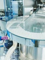 istockphoto-598676126-612×612 Pharmaceutics. Pharmaceutical industry worker operates tablet blister and cartoning packaging machine at factory