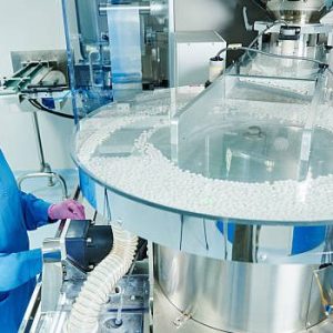 istockphoto-598676126-612×612 Pharmaceutics. Pharmaceutical industry worker operates tablet blister and cartoning packaging machine at factory